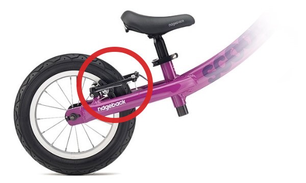 The rear brakes highlighted on a kids balance bike